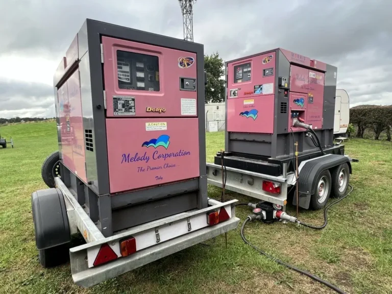 Two large, portable generator hire melody corporation units mounted on trailers at an outdoor location.